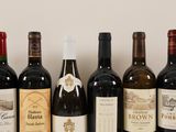 several bottles of wine are lined up in a row on a table