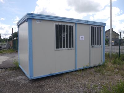 an image of a portable building in the middle of a parking lot