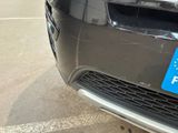 a close up of a car with a blue sticker on the front of it