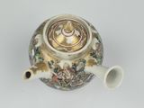 an image of a teapot on a white surface with a gold lid