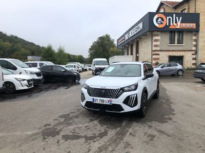 a white car parked in front of a building in a parking lot