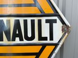 a sign that says renault on it in front of a building