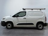 the white van is parked on the concrete floor in the room