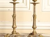 pair of antique brass candlesticks on a marble floor
