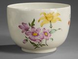 a white bowl with flowers painted on the side of it