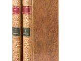 an old book sitting on top of a wooden book case