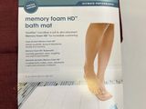 a book with a picture of a woman ' s feet on a bath mat