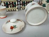 many different types of vases and bowls sitting on a table