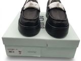 pair of black and white shoes sitting on top of a white box