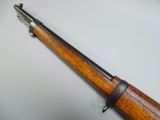 a close up of a rifle on a white surface