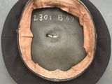 a black hat with a brown band and a number on it