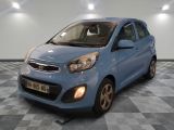 the small blue car is parked on a checkered tile floor