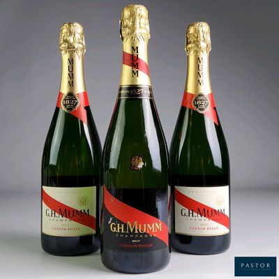 three bottles of champagne sitting next to each other on a table
