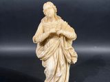 a statue of a woman holding a baby in her arms