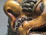a close up of a statue of a lion with its mouth open