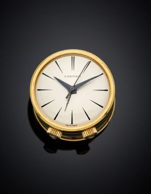 an image of a close up of a gold clock on a black surface