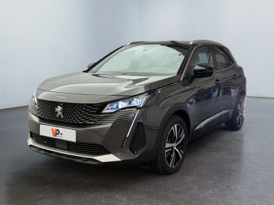 the front view of a dark colored car parked in a room