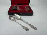 silverware in a case with spoons and spoons on a table