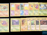 several pokemon cards are displayed on a black surface