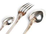 two spoons, a fork and a spoon on a white surface