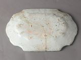 a white plate with a brown design on it