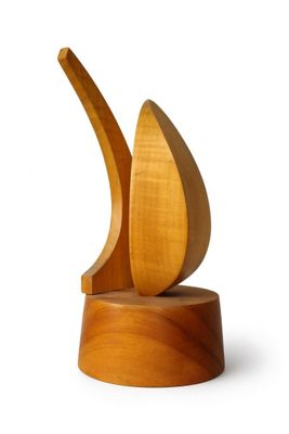 a wooden sculpture of a sailboat on a stand