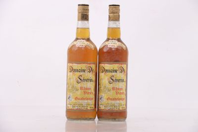 two bottles of liquor sitting next to each other on a table