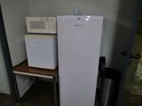 a refrigerator and a microwave in a small room