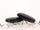 pair of glasses and eyeglass case on a white surface