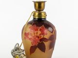 an image of a glass bottle with a flower design on it