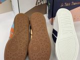 two pairs of shoes are sitting next to each other on a table
