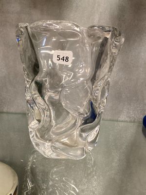 un vase en verre posé sur une table en verre sur laquelle figure un numéro