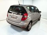 a silver car that is parked in a white room