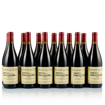 six bottles of red wine lined up in a row
