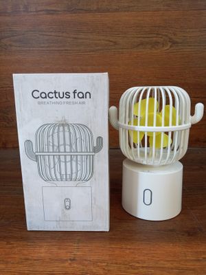 a box with a tennis ball inside of it and a cage with a tennis ball inside of it