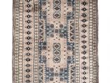 an antique rug with a blue and beige design