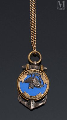 a close up of a necklace with an anchor on it