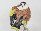 a figurine of a bird sitting on top of a table