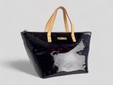a black and white tote bag sitting on top of a white surface