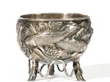 a silver bowl with two fish on it