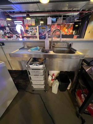 a kitchen with a sink and a refrigerator in it