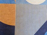a blue and yellow rug with a geometric design on it