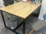 a desk with a chair and a laptop on it