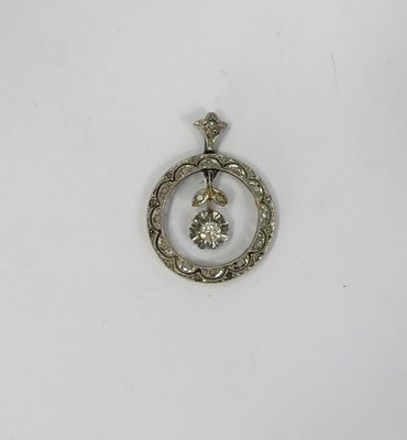 a close up of a silver pendant with a diamond in the center