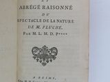 an open book on a white surface with a black and white title