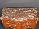an antique marble topped chest of drawers on a black background
