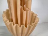 a vase that has a bunch of folded paper in it