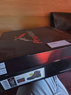 a box that is sitting on a bed with a remote in it