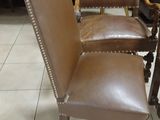 a brown leather chair that is sitting on a tile floor