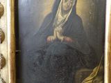 an old painting of a woman with a rosary in a gold frame
